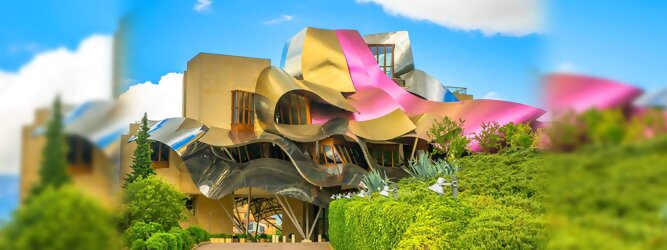 Trip Ibiza Reisetipps - Marqués de Riscal Design Hotel, Bilbao, Elciego, Spanien. Fantastisch galaktisch, unverkennbar ein Werk von Frank O. Gehry. Inmitten idyllischer Weinberge in der Rioja Region des Baskenlandes, bezaubert das schimmernde Bauobjekt mit einer Struktur bunter, edel glänzender verflochtener Metallbänder. Glanz im Baskenland - Es muss etwas ganz Besonderes sein. Emotional, zukunftsweisend, einzigartig. Denn in dieser Region, etwa 133 km südlich von Bilbao, sind Weingüter normalerweise nicht für die Öffentlichkeit zugänglich.